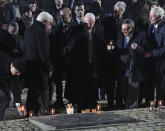 Germany's President Frank-Walter Steinmeier and his wife Elke Buedenbender, front row left, Israel's President Reuven Rivlin, center, and holocaust survivor Marian Turski, second right, attend commemorations at the Auschwitz Nazi death camp in Oswiecim, Poland, Monday, Jan. 27, 2020. Survivors of the Auschwitz-Birkenau death camp gathered for commemorations marking the 75th anniversary of the Soviet army's liberation of the camp, using the testimony of survivors to warn about the signs of rising anti-Semitism and hatred in the world today. (AP Photo/Czarek Sokolowski)