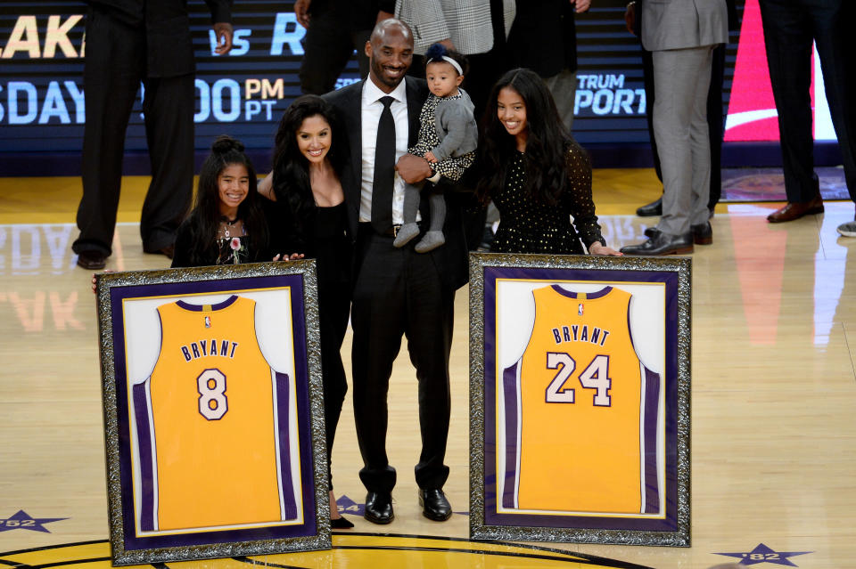 Kobe Bryant poses with his family after both his Los Angeles Lakers jerseys, numbers 8 and 24, are retired at the Staples Center on Dec. 18, 2017. (Photo: Maxx Wolfson via Getty Images)