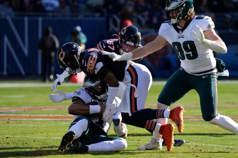 Philadelphia Eagles' Jalen Hurts, left, is hit by Chicago Bears' Jaquan Brisker during the first half on Sunday, Dec. 18, 2022, in Chicago.