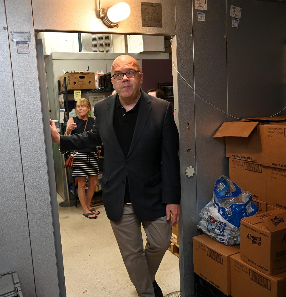 U.S. Rep. Jim McGovern pokes his head in the refrigerator while getting a tour of Daniel's Table in Framingham, June 28, 2022. A discussion between the congressman and Daniel's Table founder David Blais centered around food insecurity solutions.