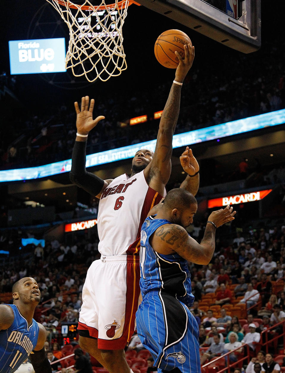 MIAMI, FL - DECEMBER 18: LeBron James #6 of the Miami Heat shoots over Glen Davis #11 of the Orlando Magic during a preseason game at AmericanAirlines Arena on December 18, 2011 in Miami, Florida. (Photo by Mike Ehrmann/Getty Images)