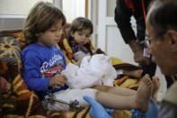 A doctor helps a boy during his rehabilitation in a hospital south of Mosul, Iraq, April 11, 2017. Picture taken April 11, 2017. REUTERS/Marko Djurica