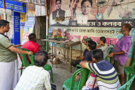 Trinamool Congress Party supporters watch news on television at a roadside stall filled with portraits of Chief Minister Mamata Banerjee and her nephew Abhishek Banerjee during the counting of votes in India's national election in Kolkata, India, Tuesday, June 4, 2024. Prime Minister Narendra Modi's Hindu nationalist party showed a comfortable lead Tuesday, according to early figures reported by India's Election Commission, but was facing a stronger challenge from the opposition than had been expected. (AP Photo/Bikas Das)