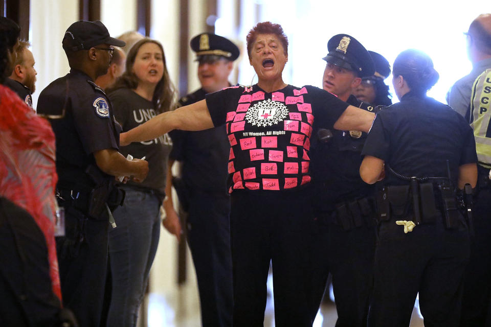 Demonstrators are arrested by U.S. Capitol police while protesting against Republican health care reform legislation outside the offices of Sen. Cory Gardner (R-Colo.) in the Russell Senate Office Building on Capitol Hill.