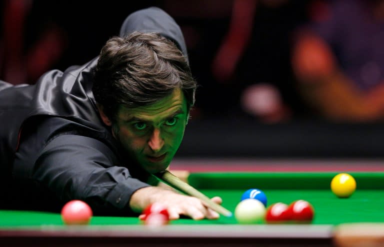 England's Ronnie O'Sullivan plays a shot during the Masters Snooker final against England's Barry Hawkins at Alexandra Palace in north London on January 17, 2016