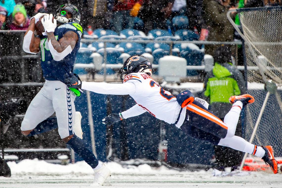 Seattle Seahawks wide receiver DK Metcalf (14) catches a pass by Chicago Bears cornerback Thomas Graham Jr. (27) during the first quarter of an NFL game on Sunday afternoon at Lumen Field in Seattle. Metcalf scored on the reception from quarterback Russell Wilson (3).