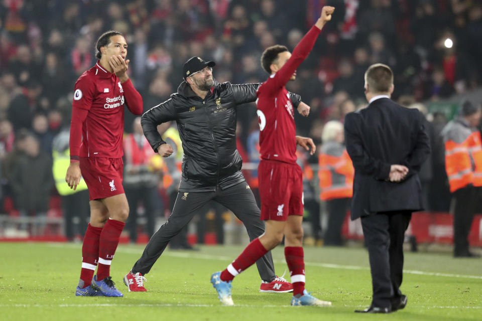 Liverpool coach Juergen Klopp, center, celebrates at the end of the English Premier League soccer match between Liverpool and Newcastle at Anfield Stadium, in Liverpool, England, Wednesday, Dec. 26, 2018. (AP Photo/Jon Super)