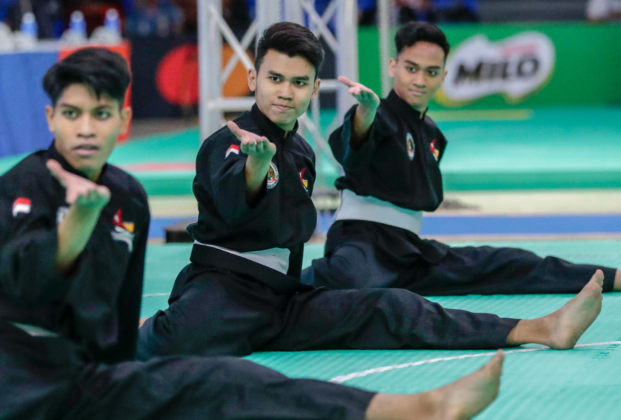 Singapore silat athletes (from left) Kamal Nazrul, Hamillatu Arash and Nujaid Hasif clinch a SEA Games gold medal in the men's seni regu (artistic team) event in Subic. (PHOTO: Sport Singapore)