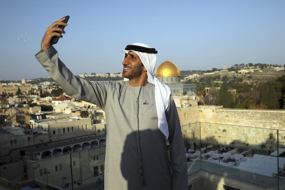 Emirati singer Walid Aljasim, uses his phone overlooking the Dome of the Rock mosque during his visit in Jerusalem, Thursday, Dec. 3, 2020. (AP Photo/Mahmoud Illean)