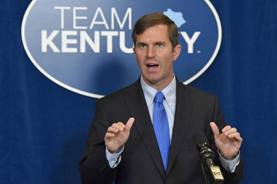 Kentucky Governor Andy Beshear speaks to reporters following the signing of bills related to the American Rescue Plan Act at the Kentucky State Capitol in Frankfort, Ky., Wednesday, April 7, 2021. (AP Photo/Timothy D. Easley)