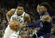 Milwaukee Bucks' Giannis Antetokounmpo, left, drives to the basket against Minnesota Timberwolves' Robert Covington during the first half of a preseason NBA basketball game Thursday, Oct. 17, 2019, in Milwaukee. (AP Photo/Aaron Gash)