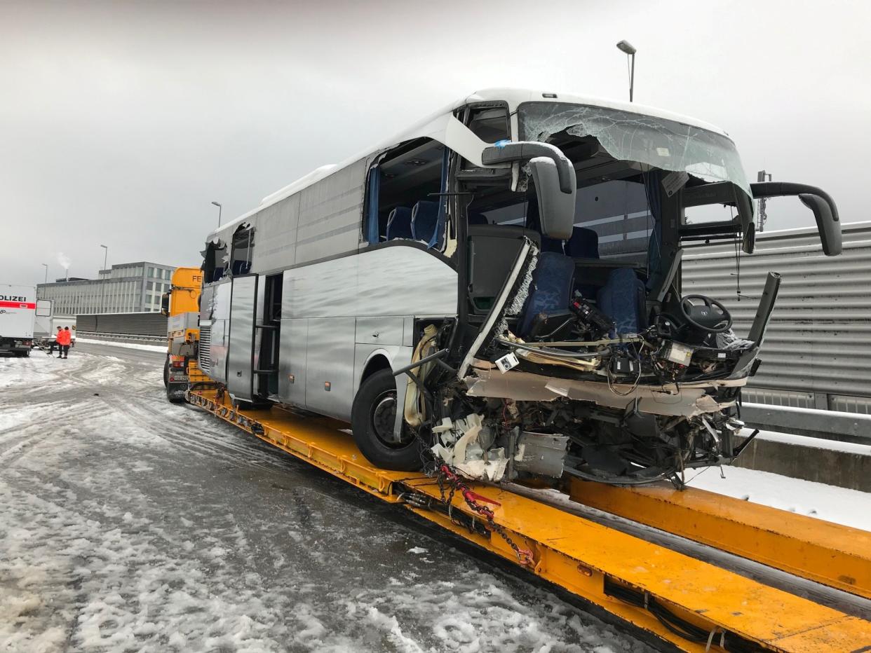 The wreckage of a bus is loaded on a trailer after an accident on the A3 motorway in Zurich: REUTERS