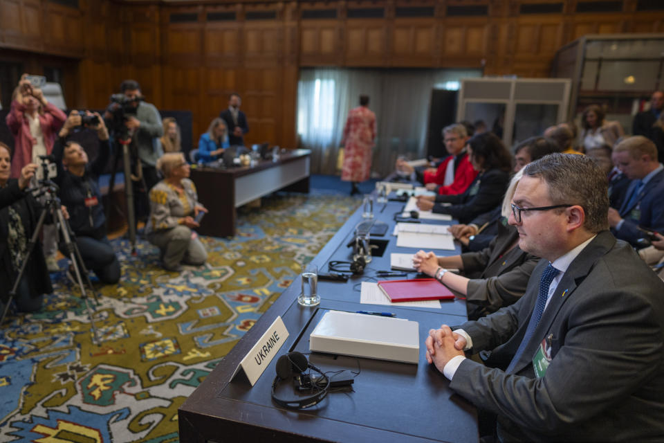 Ukraine's agent Anton Korynevych, ambassador-at-large of the Ukraine Foreign Ministry, right, waits to address the judges at the World Court where Ukraine's legal battle against Russia over allegations of genocide used by Moscow to justify its 2022 invasion, resumed in The Hague, Netherlands, Tuesday, Sept. 19, 2023. Russia seeks to have a groundbreaking case tossed out at the International Court of Justice, also known as the Word Court, in a case which will see Ukraine supported by a record 32 other nations in a major show of support for the embattled nation.(AP Photo/Peter Dejong)