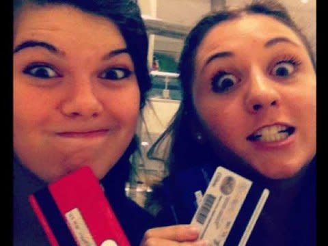 girls holding credit cards making fun faces