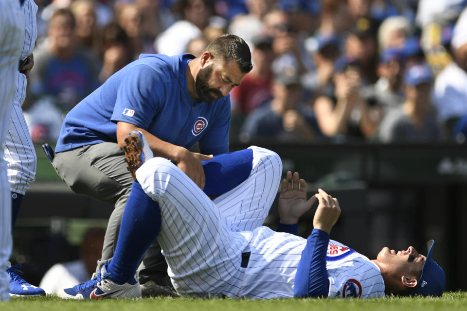 Chicago Cubs' Anthony Rizzo is tended to after spraining his ankle during the third inning of a baseball game against the Pittsburgh Pirates Sunday, Sept. 15, 2019, in Chicago. (AP Photo/Paul Beaty)