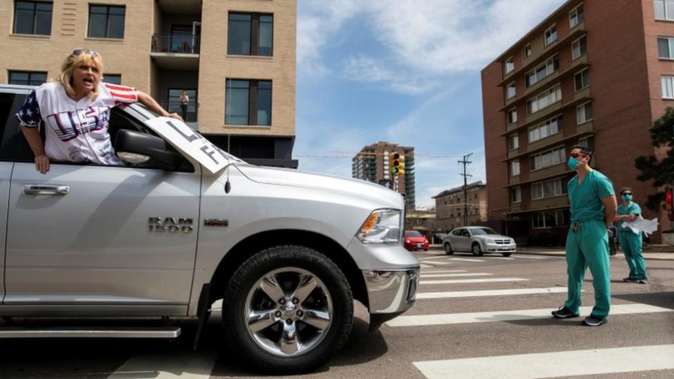 Protesters in Denver pushing for an economic reopening are met with counter-protesters dressed in scrub