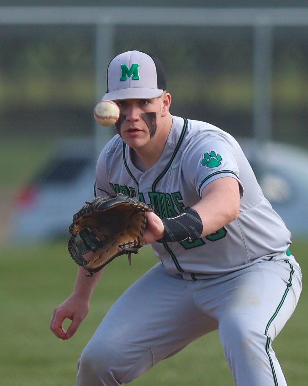 Mogadore third baseman Garrett Penix keeps his eyes on the ball to make a catch during Thursday night's game at Rootstown High School.