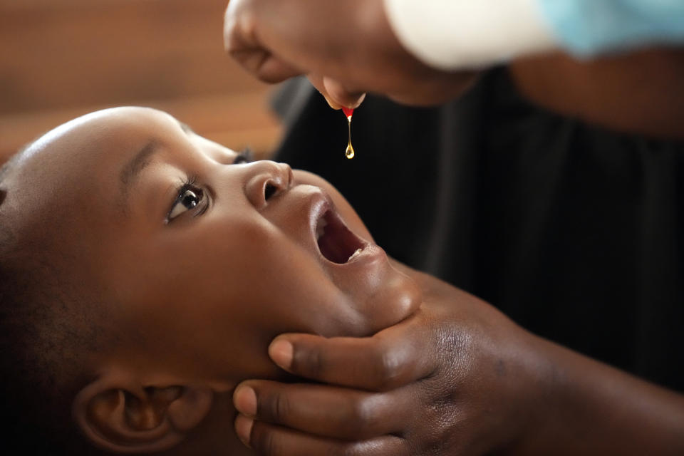 A baby recieves a vitamin booster during a measles vaccination drive at a clinic in Harare, Zimbabwe, Thursday, Sept. 15, 2022. Church members in Zimbabwe are getting their children vaccinated against measles in secret amid a deadly outbreak. It's to avoid being shunned by religious leaders who are opposed to modern medicine. (AP Photo/Tsvangirayi Mukwazhi)