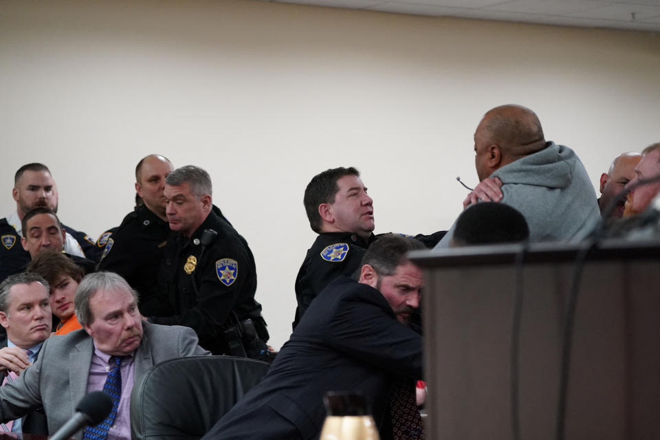 Deputies restrain a man who lunged towards convicted mass shooter Payton Gendron at his sentencing hearing in Buffalo, N.Y., on Wednesday. (Derek Gee/Pool via Reuters)