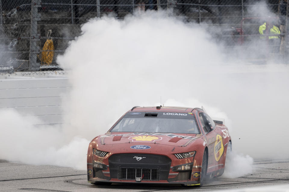 Joey Logano celebrates with a burnout after winning a NASCAR Cup Series auto race at Darlington Raceway, Sunday, May 8, 2022, in Darlington, S.C. (AP Photo/Matt Kelley)