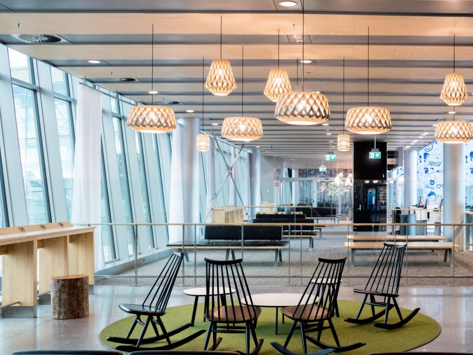 Empty interior of the Vantaa airport hall with lamp, seats and panoramic windows