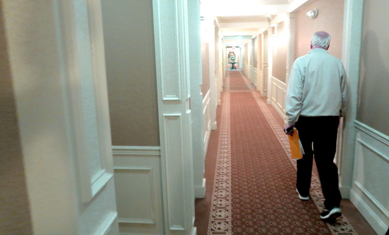 Nobility Crest community resident Bill Commons walks through a hallway in Building 2 at the Ocean Township homes Tuesday, January 24, 2024. He is spearheading an effort to get smoking banned in all the condos