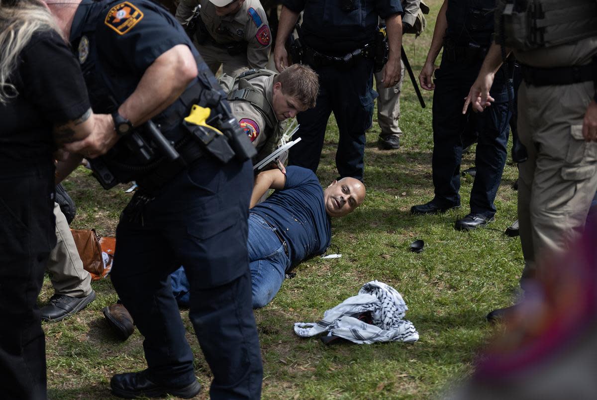 Carlos, a FOX 7 Austin photojournalist, on the ground as he is arrested while covering a pro-Palestinian protest at the University of Texas at Austin on April 24, 2024.