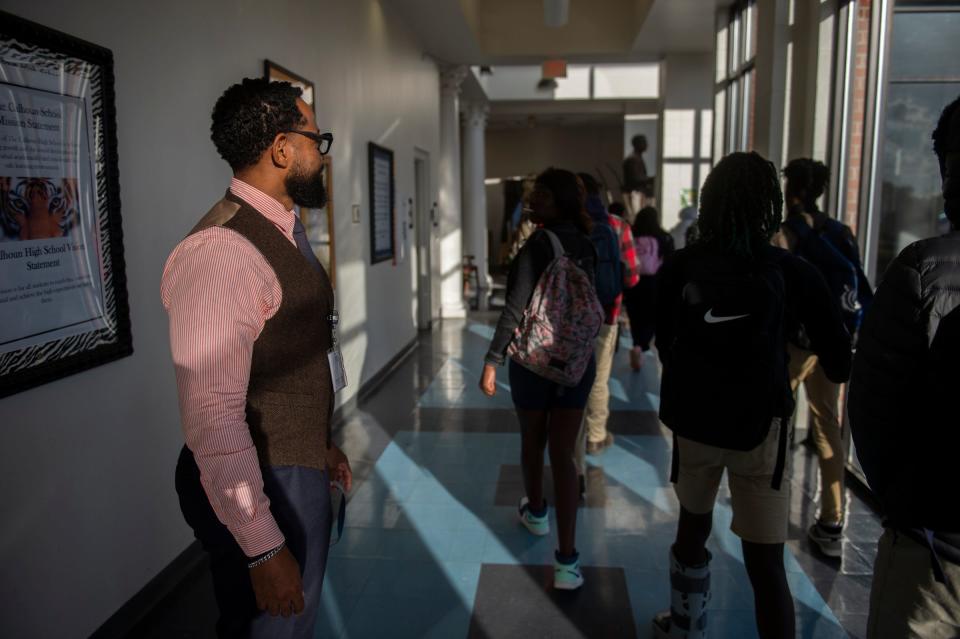 Principal Nicholas Townsend talks to students in the hallway at Calhoun High School in Letohatchee, Ala., on Wednesday, Dec. 7, 2022.