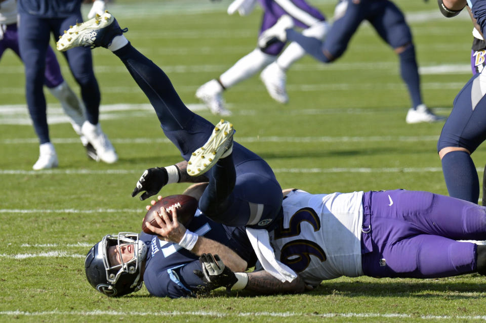 Tennessee Titans quarterback Ryan Tannehill (17) is sacked by Baltimore Ravens defensive end Derek Wolfe (95) for a 7-yard loss in the first half of an NFL wild-card playoff football game Sunday, Jan. 10, 2021, in Nashville, Tenn. (AP Photo/Mark Zaleski)