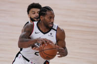 Denver Nuggets' Jamal Murray, left, reaches around for the ball as Los Angeles Clippers' Kawhi Leonard (2) looks for help during the first half of an NBA conference semifinal playoff basketball game Monday, Sept. 7, 2020, in Lake Buena Vista, Fla. (AP Photo/Mark J. Terrill)