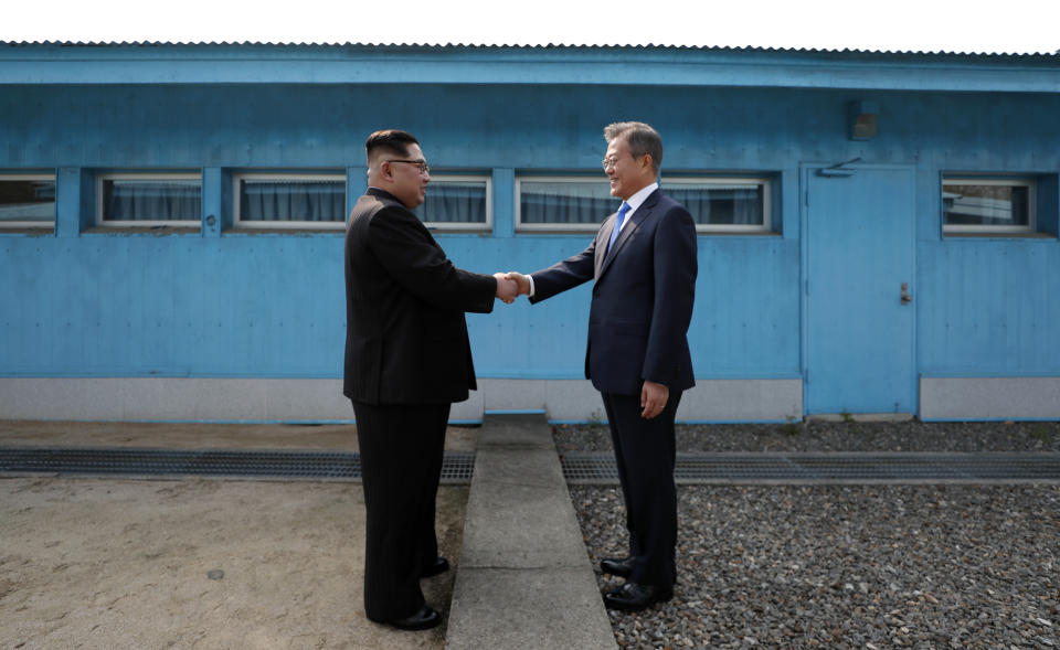 North Korea's leader Kim Jong Un shakes hands with South Korea's President Moon Jae-in at the Military Demarcation Line that divides their countries ahead of their summit at the truce village of Panmunjom on April 27, 2018.