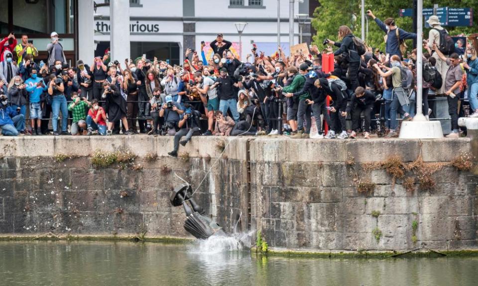 The statue of Edward Colston is thrown into Bristol harbour after protesters pulled it down.