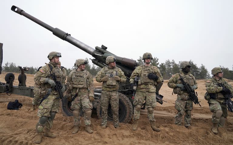 U.S. troops stand during military drills at Adazi Military base in Kadaga, Latvia, Tuesday, March. 8, 2022. (AP Photo/Roman Koksarov)