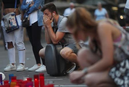 A man reacts at an impromptu memorial where a van crashed into pedestrians at Las Ramblas in Barcelona, Spain August 21, 2017. REUTERS/Susana Vera