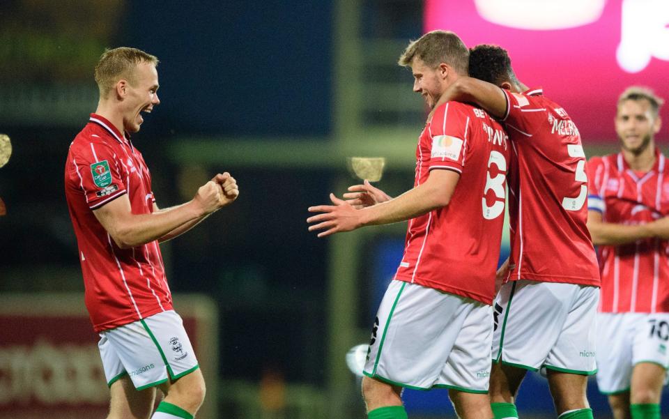 Lincoln City's James Jones, centre, celebrates scoring his side's fourth goal with team-mates Anthony Scully, left, and Max Melbourne during the Carabao Cup Second Round Northern Section match between Bradford City and Lincoln City at Utilita Energy Stadium on September 15, 2020 in Bradford, England.  - GETTY IMAGES