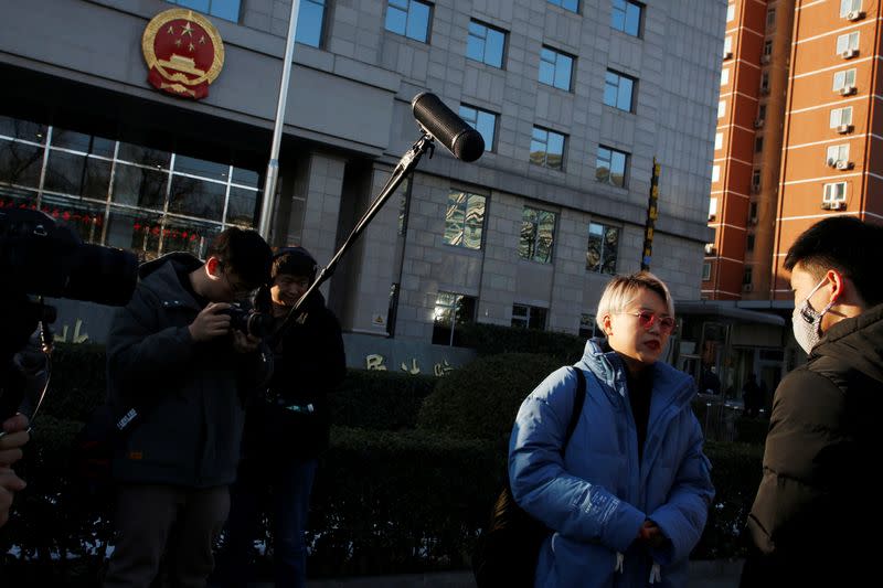 Teresa Xu talks to a supporter outside Chaoyang People's Court before a court hearing in Beijing