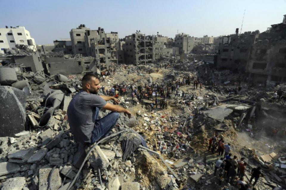 The National: A man looks over the aftermath of an Israeli airstrike in Gaza