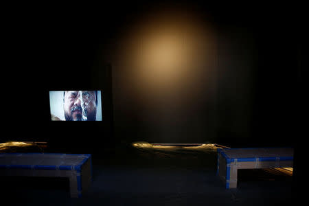 A TV set shows Chinese artist Ai Weiwei as part of his "S.A.C.R.E.D" installation during a media preview at the cathedral in Cuenca, Spain, July 21, 2016. Picture taken July 21, 2016. REUTERS/Susana Vera