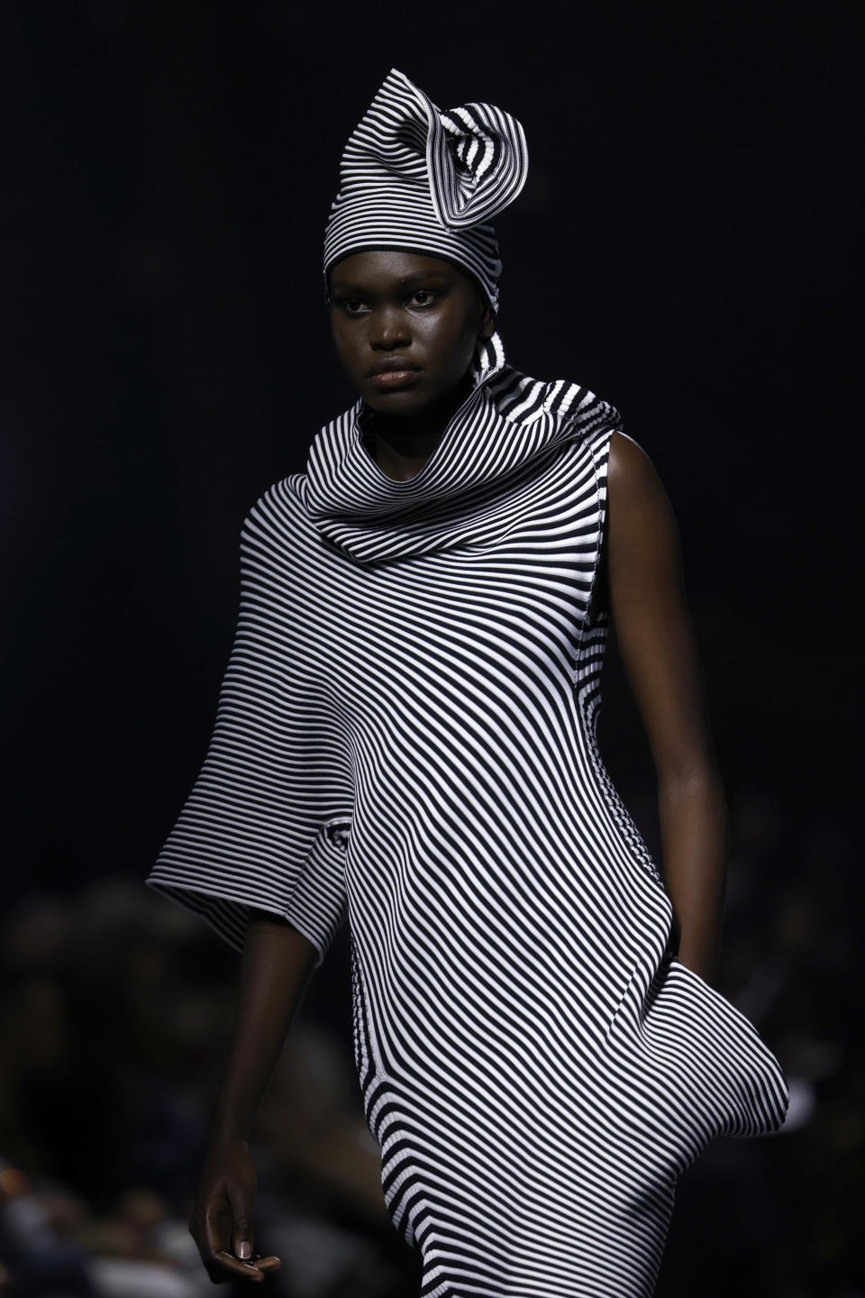 A model wears a creation as part of the Issey Miyake Fall/Winter 2023-2024 ready-to-wear collection presented Friday, March 3, 2023 in Paris. (Vianney Le Caer/Invision/AP)