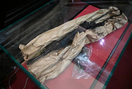 An AK-47 assault rifle and a Magnum revolver presented as evidence are displayed during the trial of Mehdi Nemmouche and Nacer Bendrer, who are suspected of killing four people in a shooting at Brussels' Jewish Museum in 2014, at Brussels' Palace of Justice, Belgium January 15, 2019. Emmanuel Dunand/Pool via REUTERS