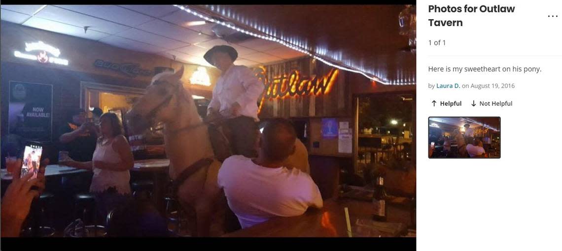 In this screenshot from a Yelp.com review, a man has ridden his horse into Outlaw Tavern in 2016.