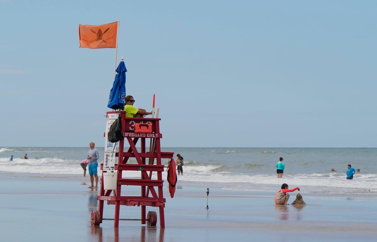 A Volusia County lifeguard keeps an eye on a handful of swimmers in Daytona Beach recently. Collections from the county's tourism tax fell again in July, the fifth consecutive month of declines.