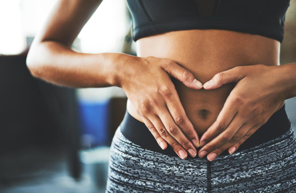 Woman holding her stomach. (Getty Images)