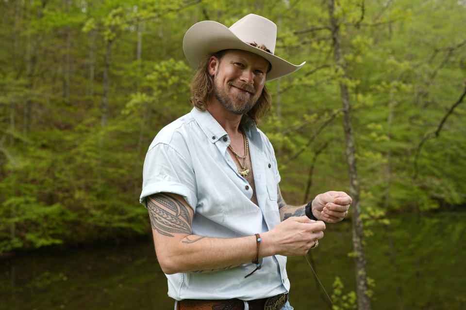 Brian Kelley poses for a portrait outside his cabin Wednesday, April 17, 2024, in Nashville, Tenn. (AP Photo/George Walker IV)