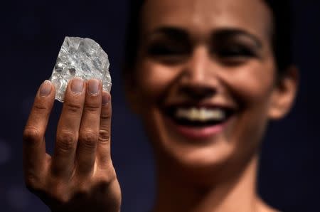 FILE PHOTO -- A model shows off the 1109 carat "Lesedi La Rona", the largest gem quality rough diamond discovered in over 100 years during a sale preview at Sotheby's auction house in London, Britain, June 14, 2016. REUTERS/Dylan Martinez/File Photo