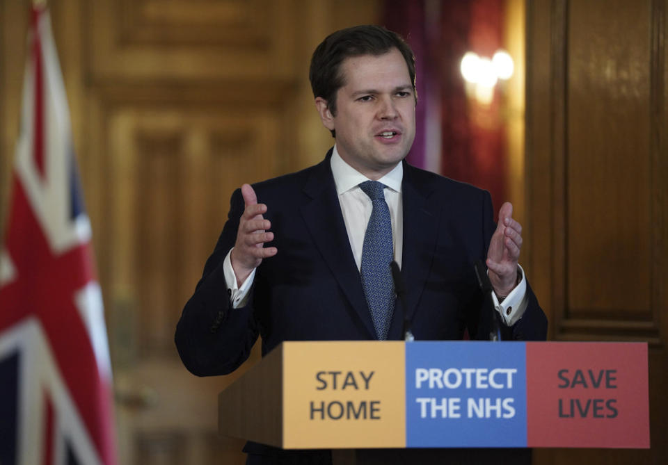 In this handout photo provided by 10 Downing Street, Housing, Communities and Local Government Secretary Robert Jenrick answering questions from the media via a video link during a media briefing on coronavirus, at 10 Downing Street in London, Sunday, March 29, 2020. The new coronavirus causes mild or moderate symptoms for most people, but for some, especially older adults and people with existing health problems, it can cause more severe illness or death. (Pippa Fowles/10 Downing Street via AP)