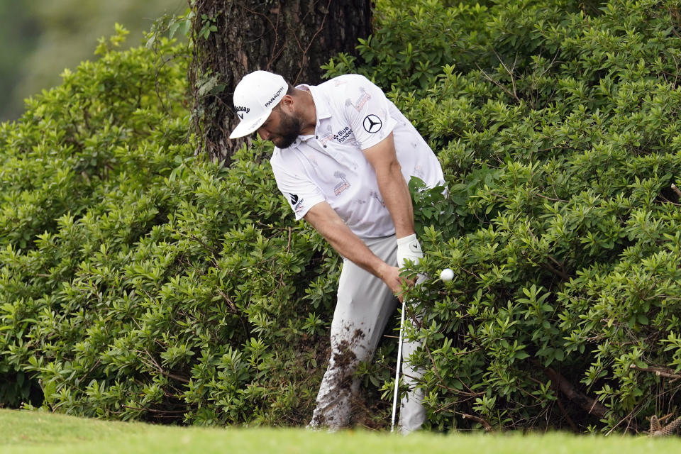 Jon Rahm hits from a shrub after his drive went into the rough on the second hole during the first round of the St. Jude Championship golf tournament Thursday, Aug. 10, 2023, in Memphis, Tenn. (AP Photo/George Walker IV)