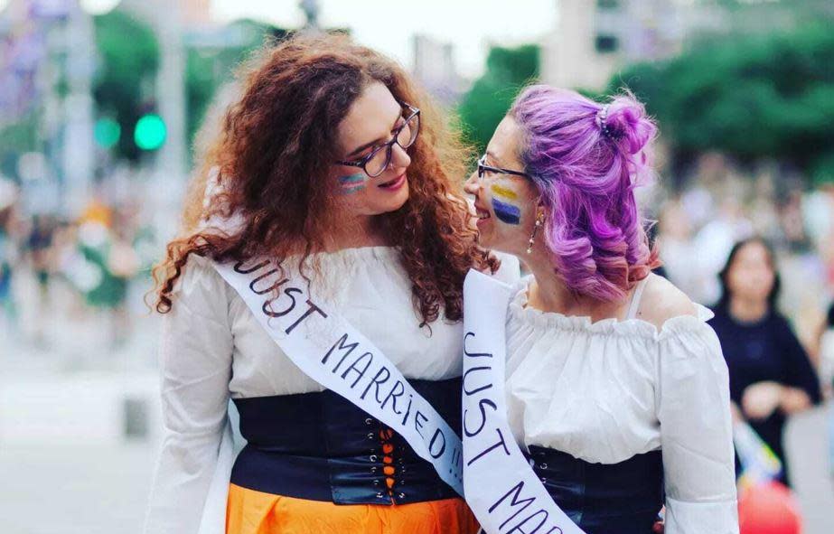 Evie (left) and Gia are seen at the Bucharest Pride March, July 9, 2022, right after their wedding ceremony  in the Romanian capital. / Credit: Courtesy of Larisa Baltă