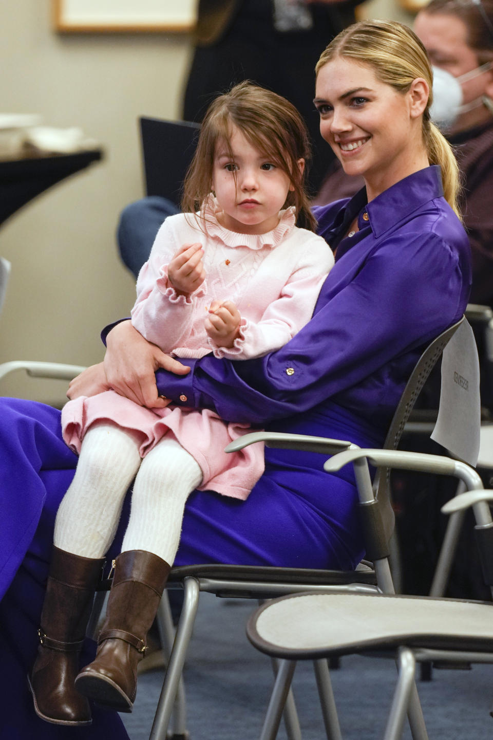 Kate Upton, and her daughter Genevieve, watch as her husband Justin Verlander participates in a baseball news conference at Citi Field, Tuesday, Dec. 20, 2022, in New York. The team introduced Verlander at a news conference after they agreed to a $86.7 million, two-year contract. It's part of an offseason spending spree in which the Mets have committed $476.7 million on seven free agents. (AP Photo/Seth Wenig)