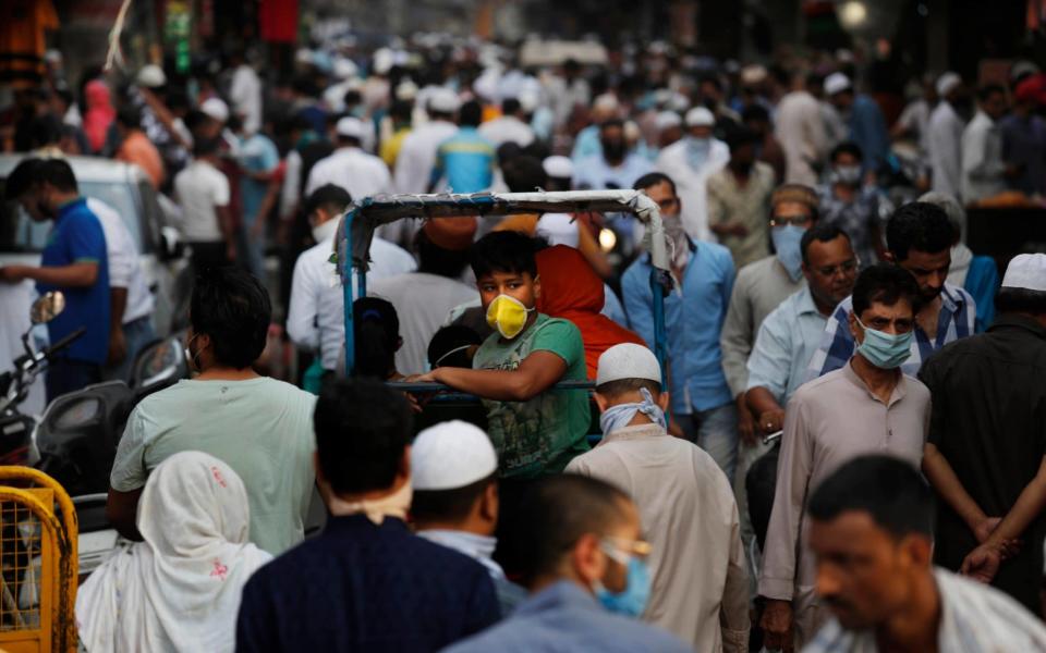 Indians shop on the eve of Eid al-Fitr, at the old quarters of New Delhi, India - AP